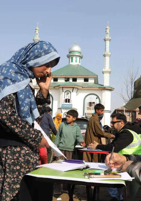 Care World team assisting community members during a food assistance programme in Kashmir